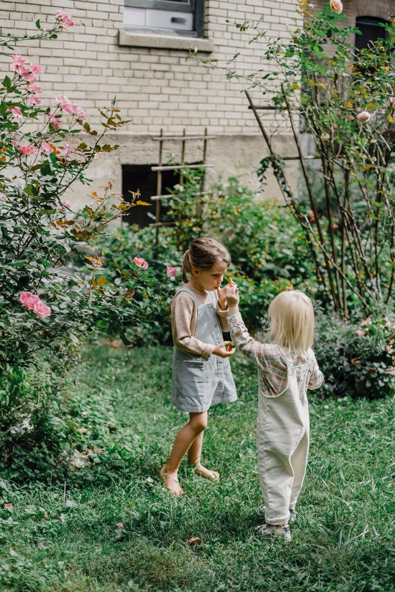 A parent lifting their laughing child into the air.